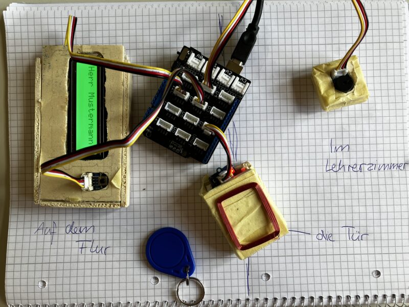 Verschiedene elektronische Bauteile wie Arduino, LED-Bildschirm, RFID-Chip auf dem Tisch